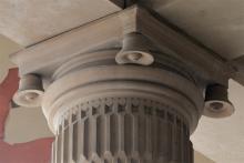 Temple bells carved on top four corners of each pillar